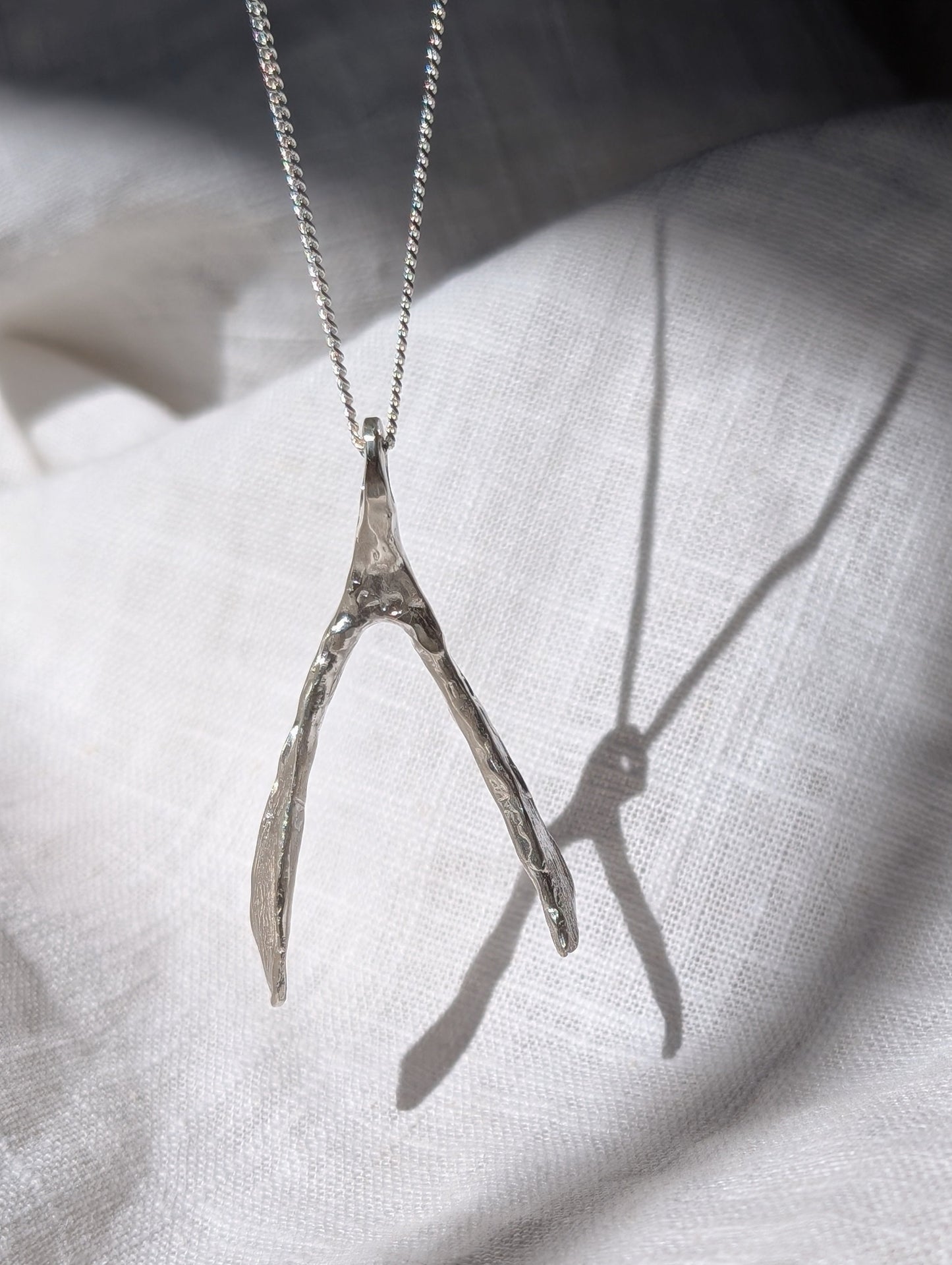 Untapped Potential silver Wishbone Pendant