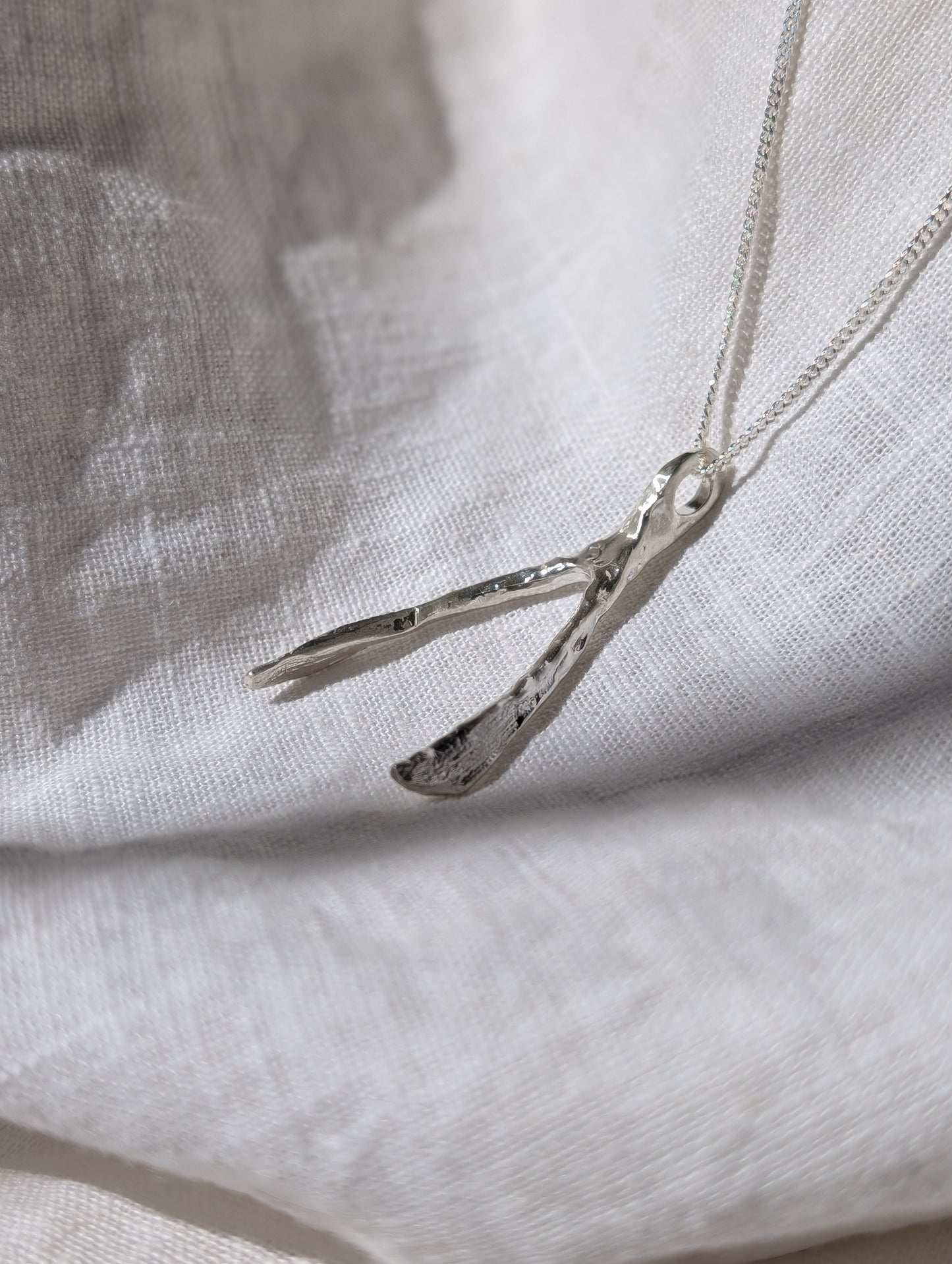 Untapped Potential silver Wishbone Pendant